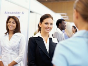 three businesswomen at an exhibition
