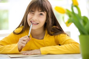 girl writing card for mother's Day